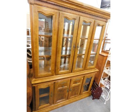 A light oak display cabinet. 