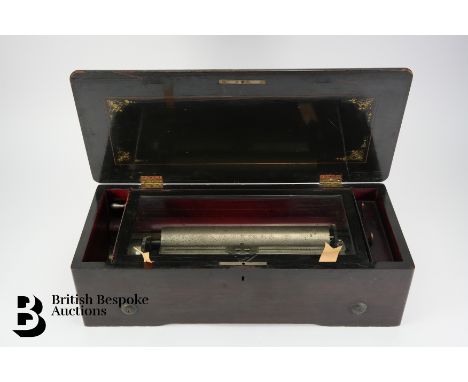 A late 19th century rosewood music box, possibly Swiss, no makers name, having an 11" white metal cylinder and comb, playing 