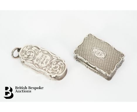 Two silver vinaigrettes; the first vinaigrette of rectangular form with engine turned design and pierced foliate grille, Birm