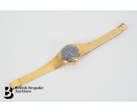 A gentleman's 18ct yellow gold manual wind Longines Conquest wrist watch. The watch having a 30mm blue face, baton markers wi