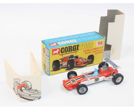 A Corgi Toys No. 158 Lotus Climax F1 racing car in orange and white body with racing No. 8 and blue driver figure (8 label on