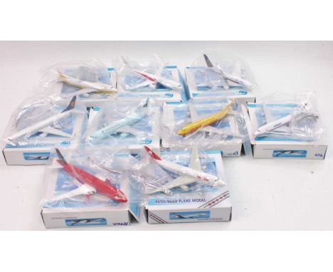 A group of 9 boxed diecast Passenger Plane Models in various liveries all still in bags approx 1:400th scale, made in Malaysi