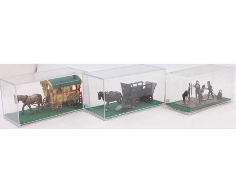 Three plastic-cased horsedrawn vehicles and dioramas to include a John Hilco bull cart with horse and driver figure, a Morest