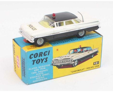 A Corgi No. 481 Chevrolet police car, black and white body with black roof, red roof light with 2 policeman figures in very n