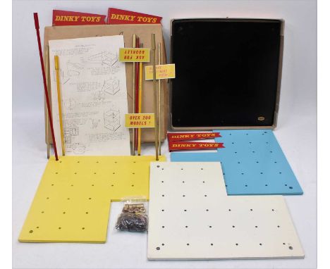 An original Dinky Toys wooden and metal shop/dealer display stand comprising of a wooden base with three shelves and various 