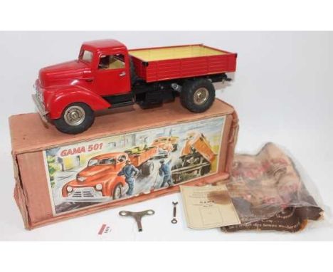 Gama No.501 battery operated and tinplate tipping truck, comprising red cab and back, black chassis, with spare tire, housed 