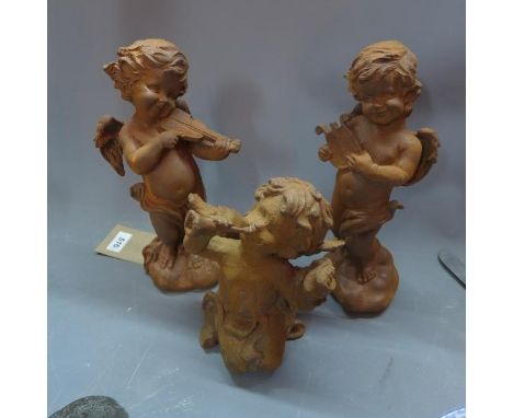 Three cast iron cherubs playing musical instruments, H. 30cm tallest (3) 