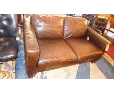 A Contemporary brown leather two seater sofa 