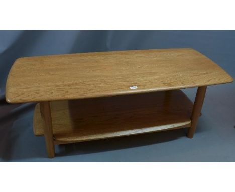 An Ercol elm two tier coffee table, H. 46 W. 128 D. 56cm 