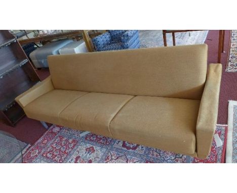 A mid 20th century Danish three seat sofa bed, with golden brown linen upholstery, raised on chrome legs 