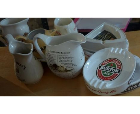 Four ceramic pub ash trays, to include Wade and Carlton ware, together with five pub water jugs 