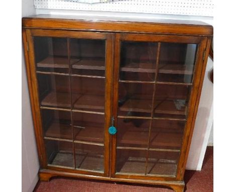 A 19th century mahogany bookcase with two glazed doors raised on bracket feet. H. 120 W. 108 D. 26cm 