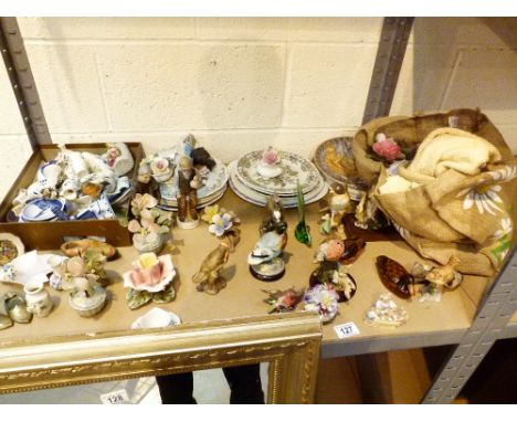 Shelf of assorted ceramic birds, animals and plates