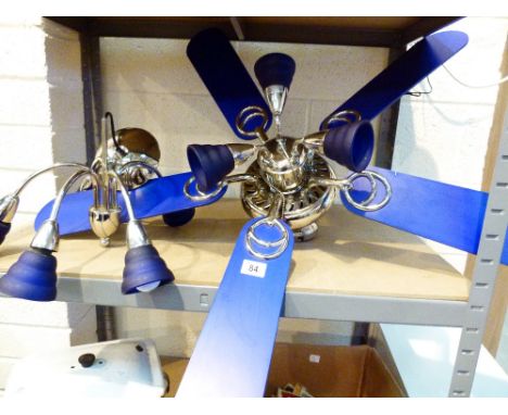 Two modern chrome and blue glass ceiling light fittings, one with built in fan