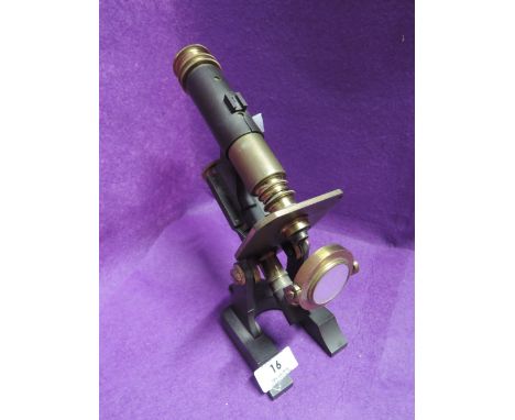 A vintage scientific microscope with brass fitments