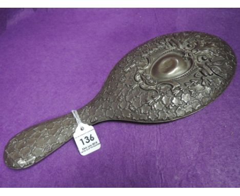 An early 20th century HM silver hand mirror having extensive moulded ivy leaf decoration