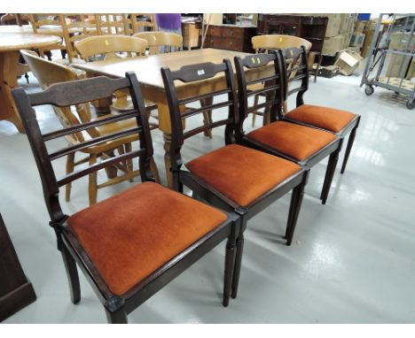 A set of four Edwardian style ladder back dining chairs