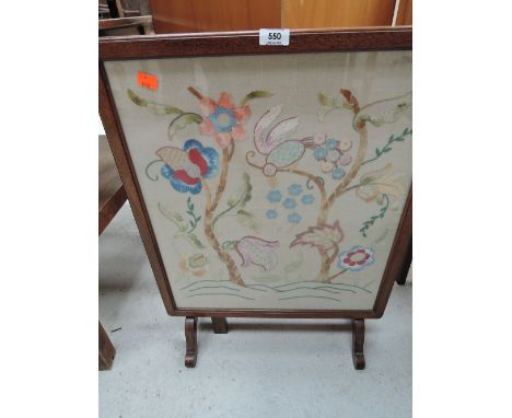 A folding fire screen/ table with embroidered decor