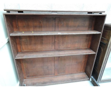 A vintage bookshelf with adjustable peg shelf by Wearing and Gillows