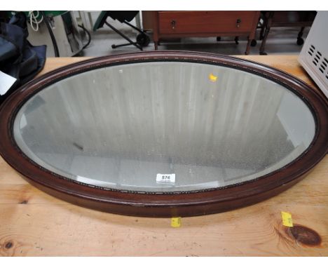 A vintage oval hallway mirror