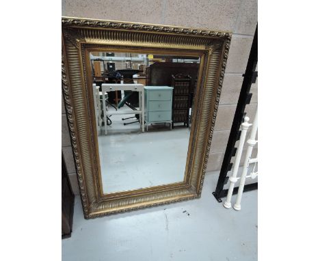 A large modern gilt frame wall mirror