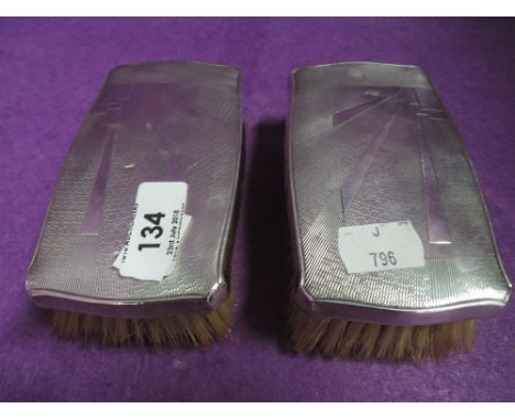 A pair of HM silver backed gents brushes having Art deco style engine turned decoration