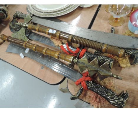 A selection of vintage medieval replica weapons, sword axe etc