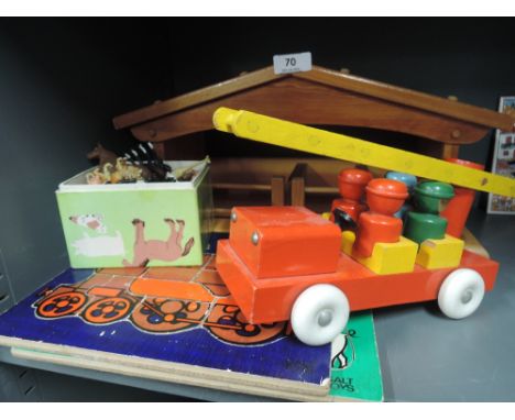 A selection of Britain's and similar plastic farm animals and wooden yard, two wooden jigsaw puzzles and fire engine