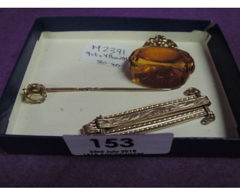 Three pieces of yellow metal and 9ct gold jewellery including stick pin and fob