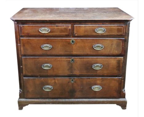 The upper section of a George III oak tallboy chest, fitted with two short and three long feather banded drawers between flut