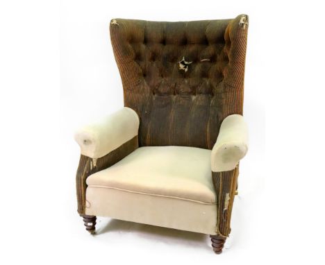 A late Victorian mahogany frame armchair, with curved button down back, on turned legs and castors.