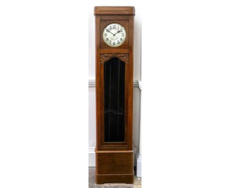 A carved oak longcase clock, circa 1930's with three train chiming movement, 208cm high x 46cm wide.