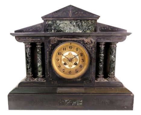 An Edwardian black slate and verde antico marble mantel clock, of architectural style, striking on a gong, 44cm wide x 26cm h