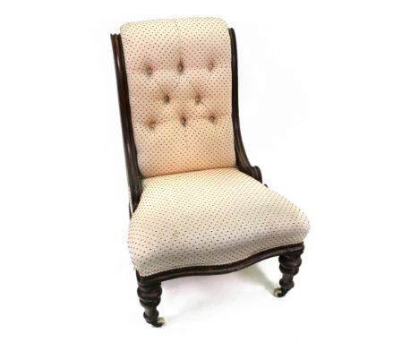 A Victorian moulded mahogany frame button down upholstered nursing chair, on turned legs and castors.