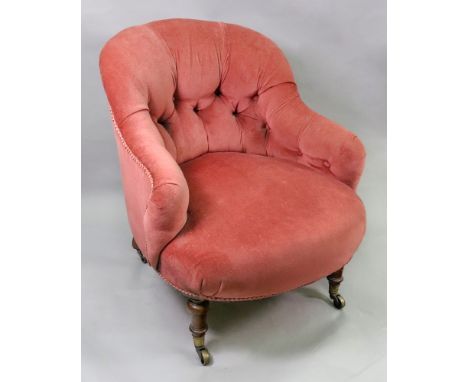 A Victorian walnut frame button down upholstered nursing chair, on turned legs and castors.