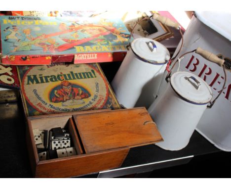Games and kitchenalia to include a bread bin, cigarette cards, Monopoly and camera accessories 