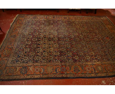 A Kurdish carpet with all over decoration (holed) 263 x 340cm 