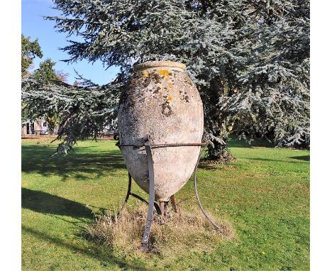 A large and impressive stone composition garden ovoid urn on wrought iron stand, standing over an estimated 8'8" tall and 5ft