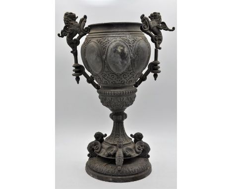 A Victorian spelter oil lamp base, in the form of a classical urn, moulded with lions and dragons, some historical repairs to