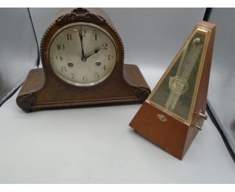 An oak cased mantel clock - no key and a metronome (foot missing)