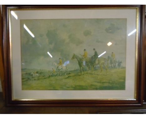 A framed print of a fox hunting scene