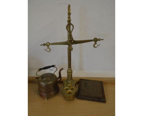 Hanging brass scales, a copper kettle and plaque