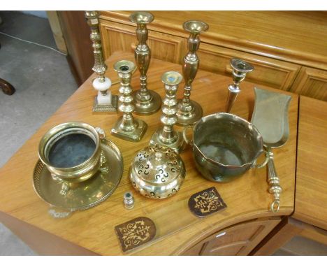 Brass candlesticks, plates, bowls, shovel and lamp. book holder not included in this lot