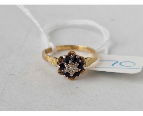 A sapphire and diamond flowerhead ring in 18ct gold size K ½  2.7g  