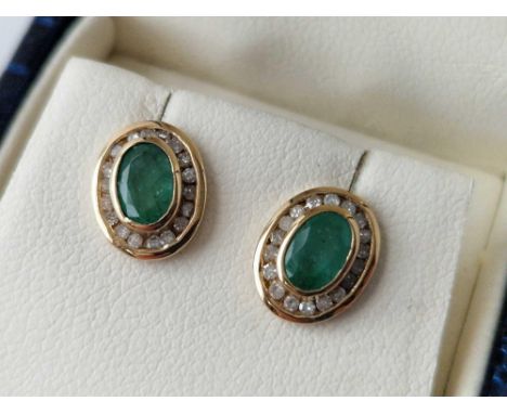 A pair of emerald and channel set diamond earrings 9ct