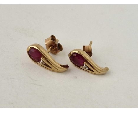 A pair of matching diamond and ruby earrings 9ct