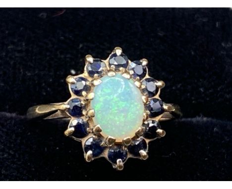 A sapphire and opal cluster ring flashing green and orange size M 2.7 gms