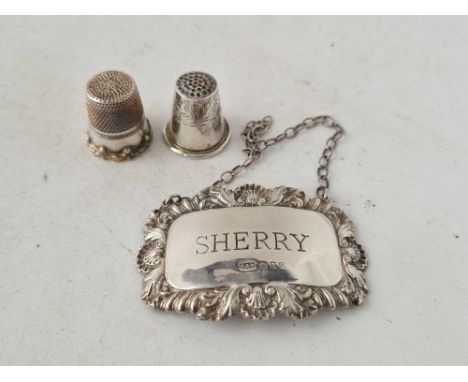 A sherry wine ticket an two thimbles