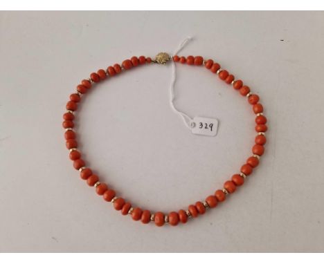 A STRING OF ANTIQUE CORAL BEADS ON A GOLD CLASP WITH GOLD SPACERS LGE BEAD 10MM 19.5 INCH 45.6 GMS