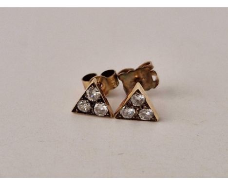 A pair of gold diamond stud earrings